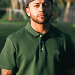 Man wearing green polo shirt on golf course