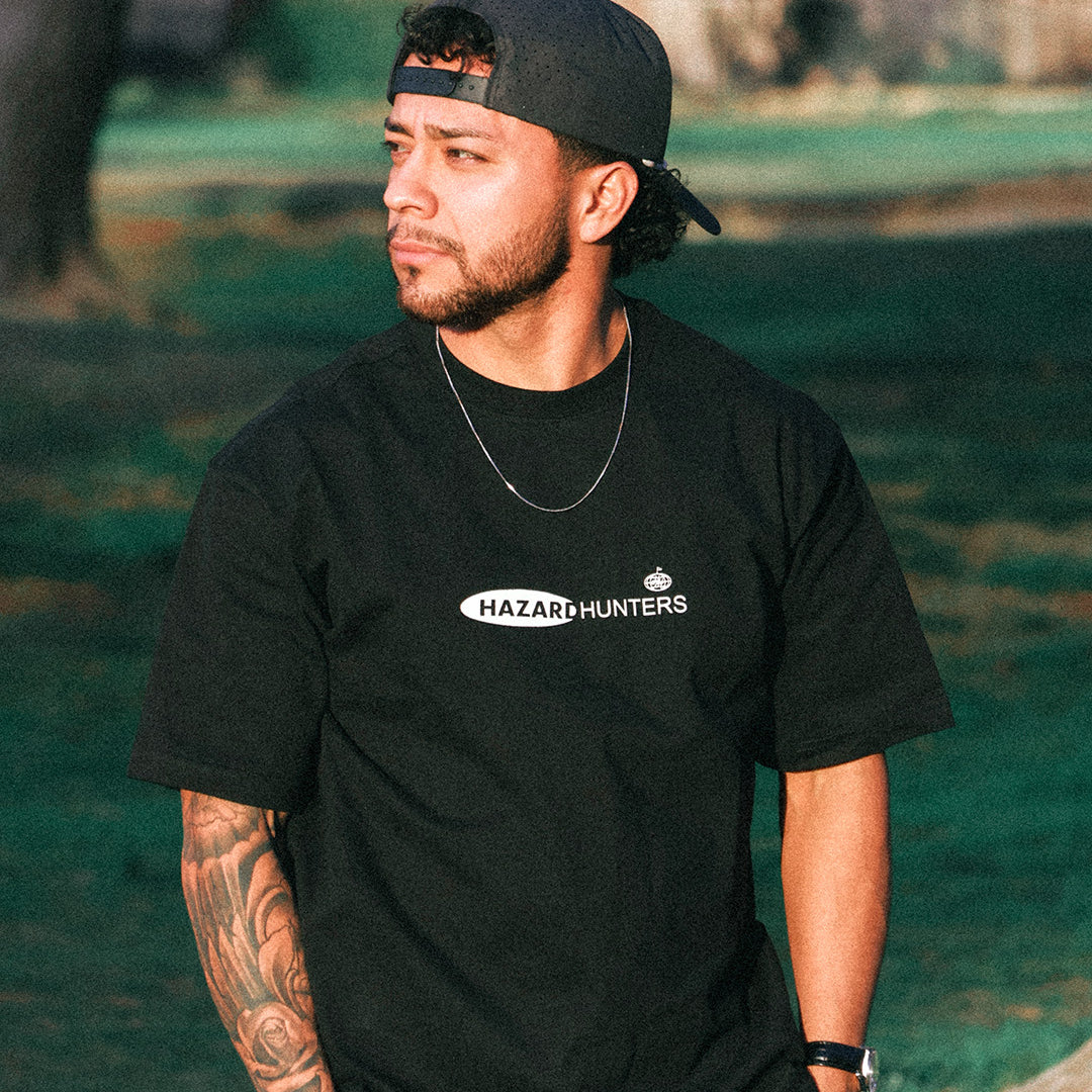 Man wearing black t-shirt in green park