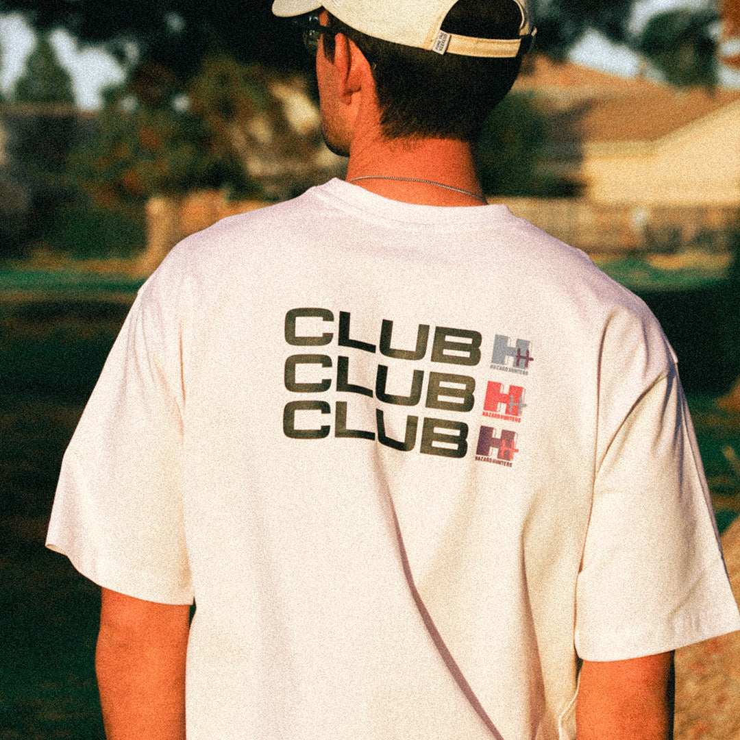 Man wearing white tshirt with Club HH on the back