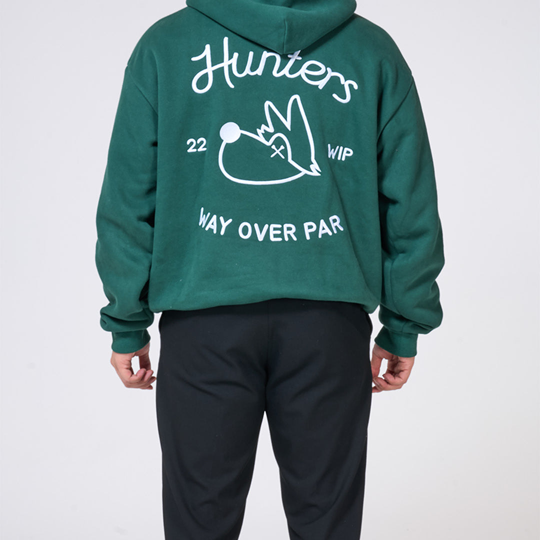 Green hoodie with white text and graphics on the back, worn by a person against a white background