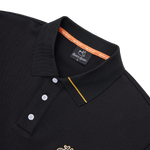 Black polo shirt with a brand label on a white background
