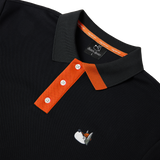 Black polo shirt with orange collar and white logo on a white background
